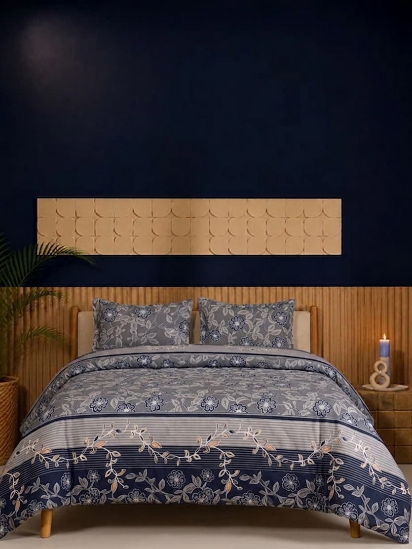 Bed with blue floral bedding and wooden headboard against a dark wall