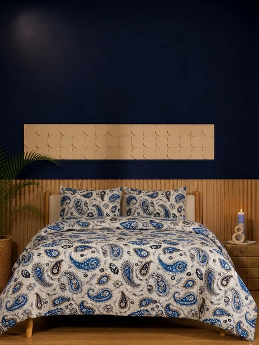 Bed with paisley patterned comforter in a bedroom setting