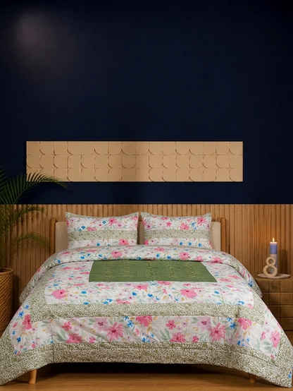 Floral quilt on a bed with a wooden headboard against a dark wall.