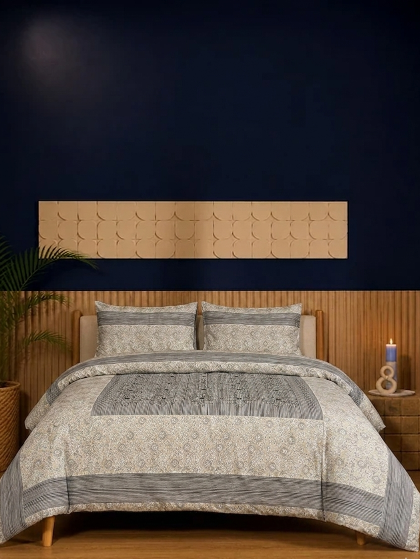 Bed with patterned bedding and wooden headboard against a dark wall
