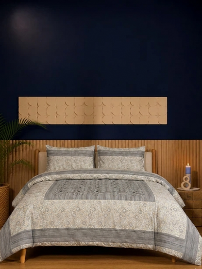 Bed with patterned bedding and wooden headboard against a dark wall